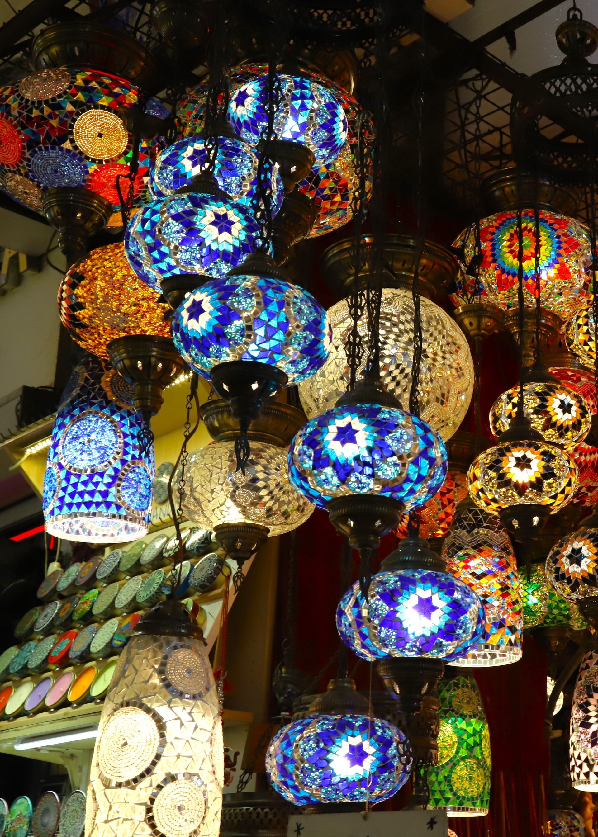 A bunch of colorful lamps are hanging from the ceiling
