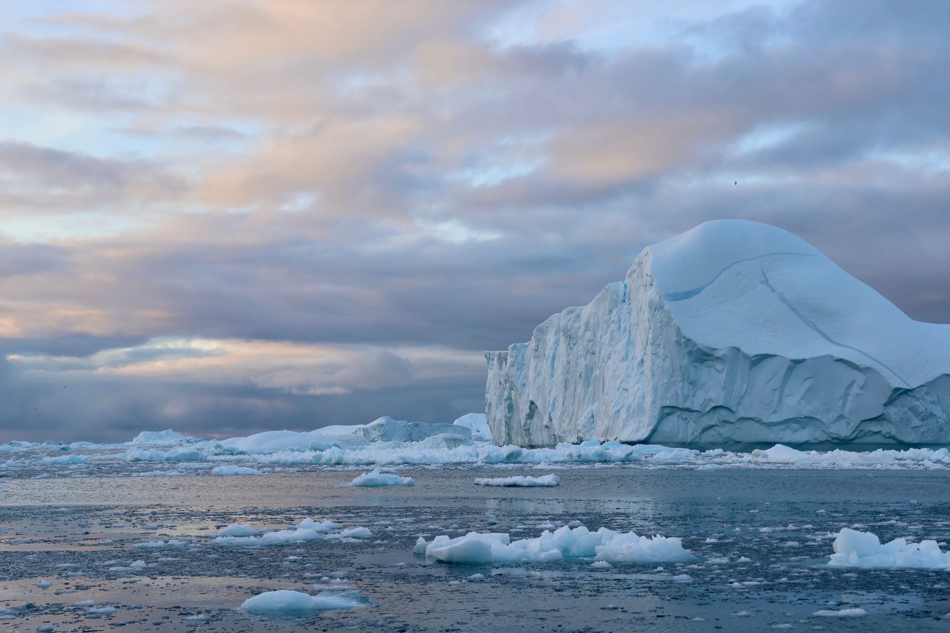 There is a large iceberg in the middle of the ocean.