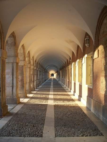 A long hallway with arched ceilings and columns