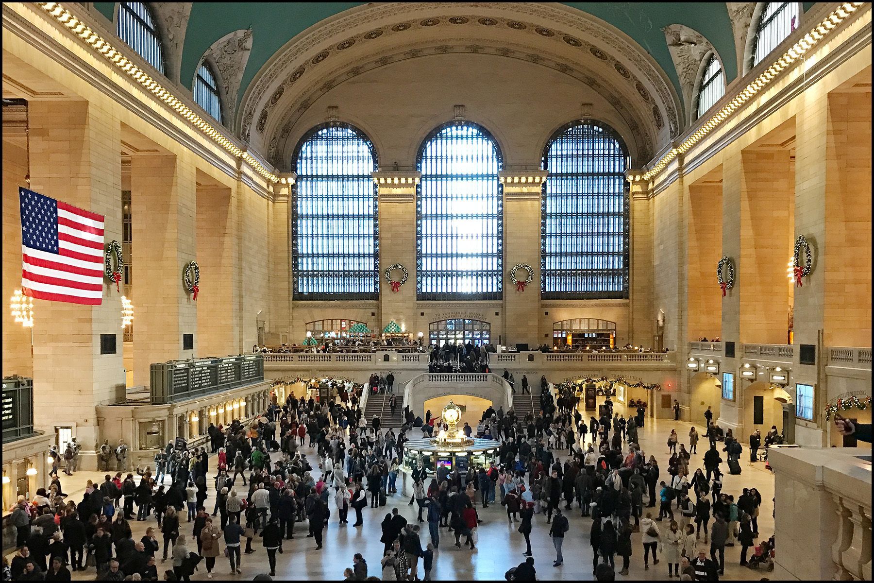 A large crowd of people are gathered in a large building