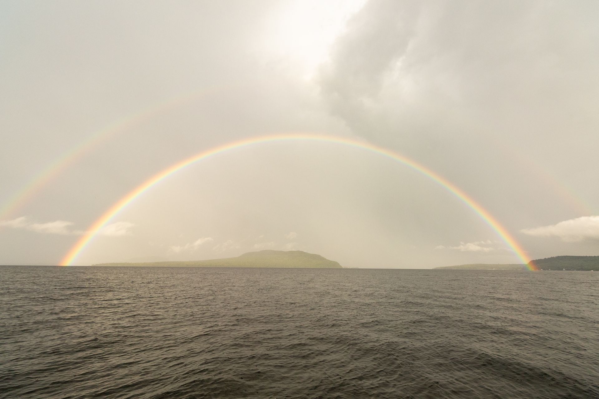There is a double rainbow over the ocean.