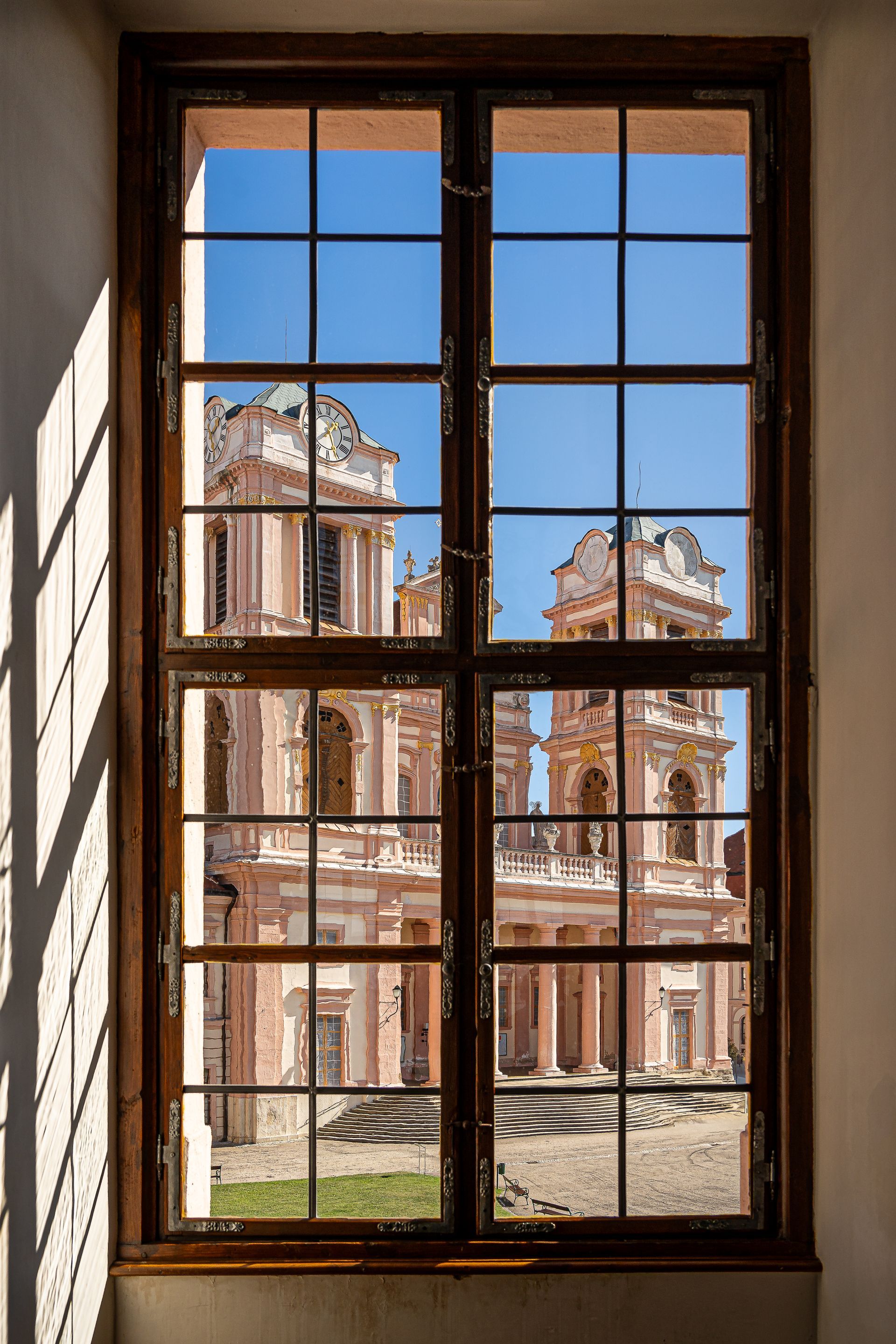 A window with a view of a building through it.