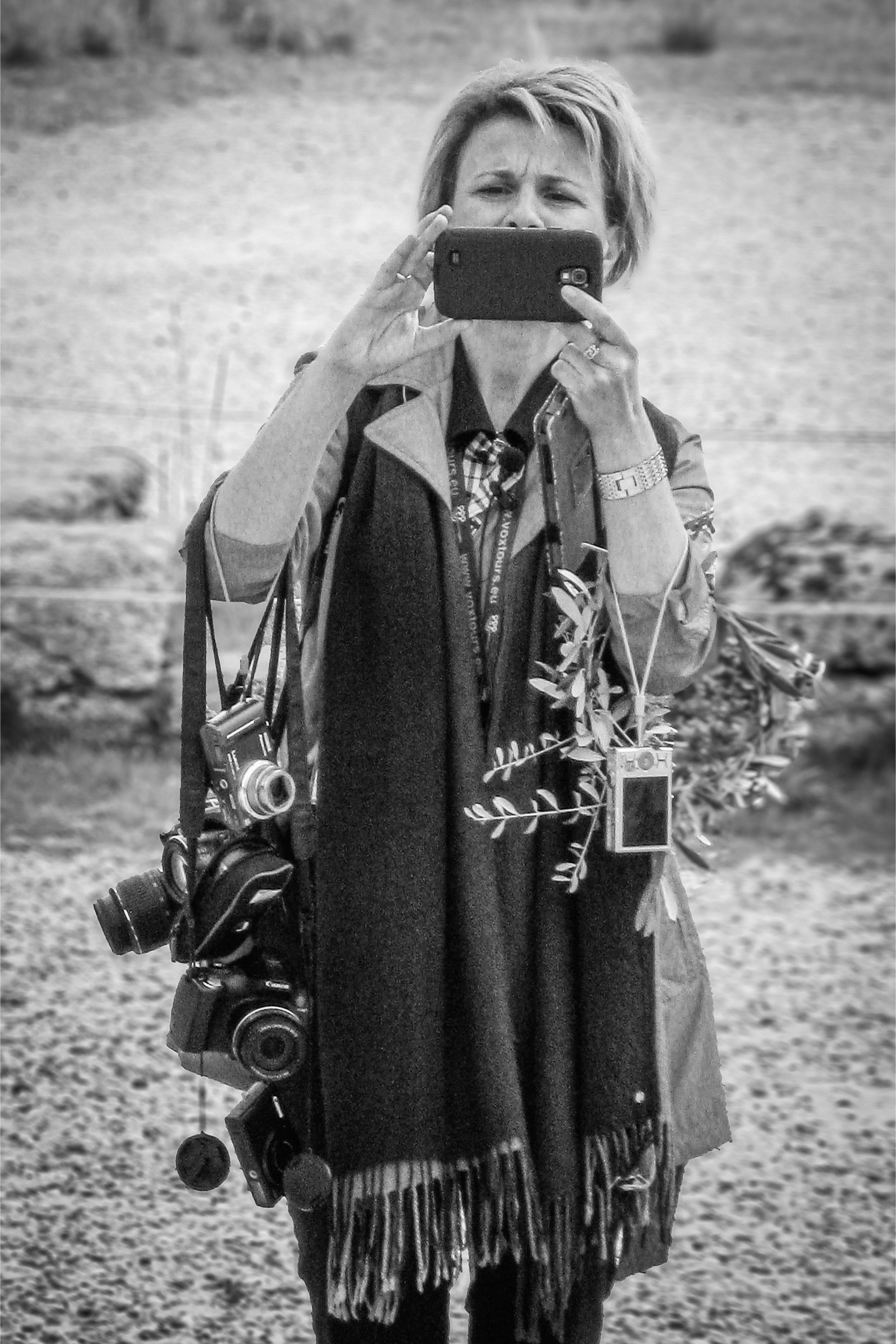 A woman is taking a picture of herself with a cell phone.