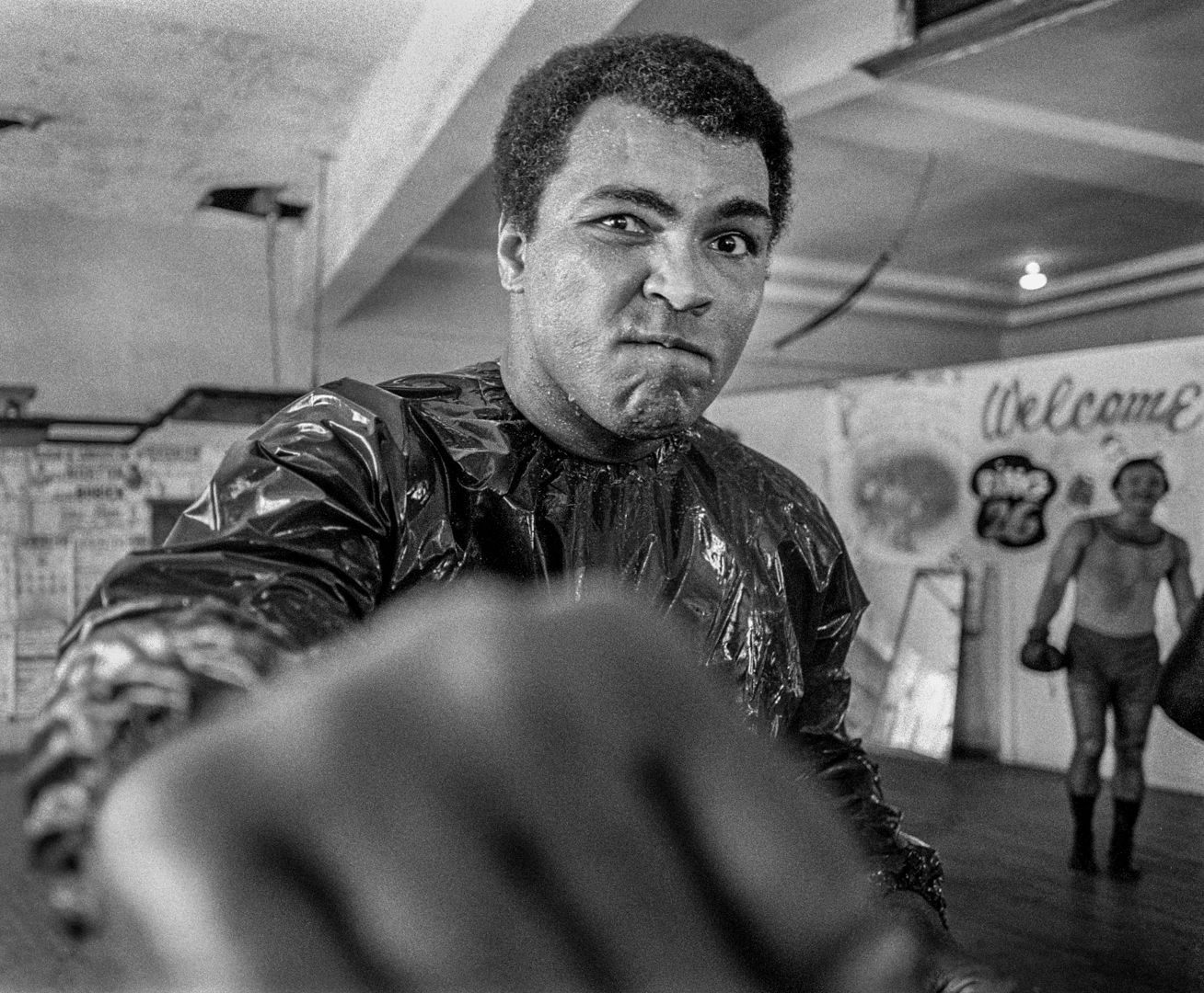 A black and white photo of a man in a boxing ring.