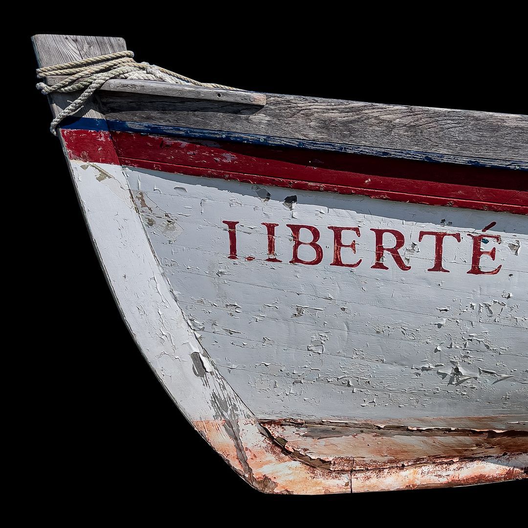 The word liberte is on the side of a boat