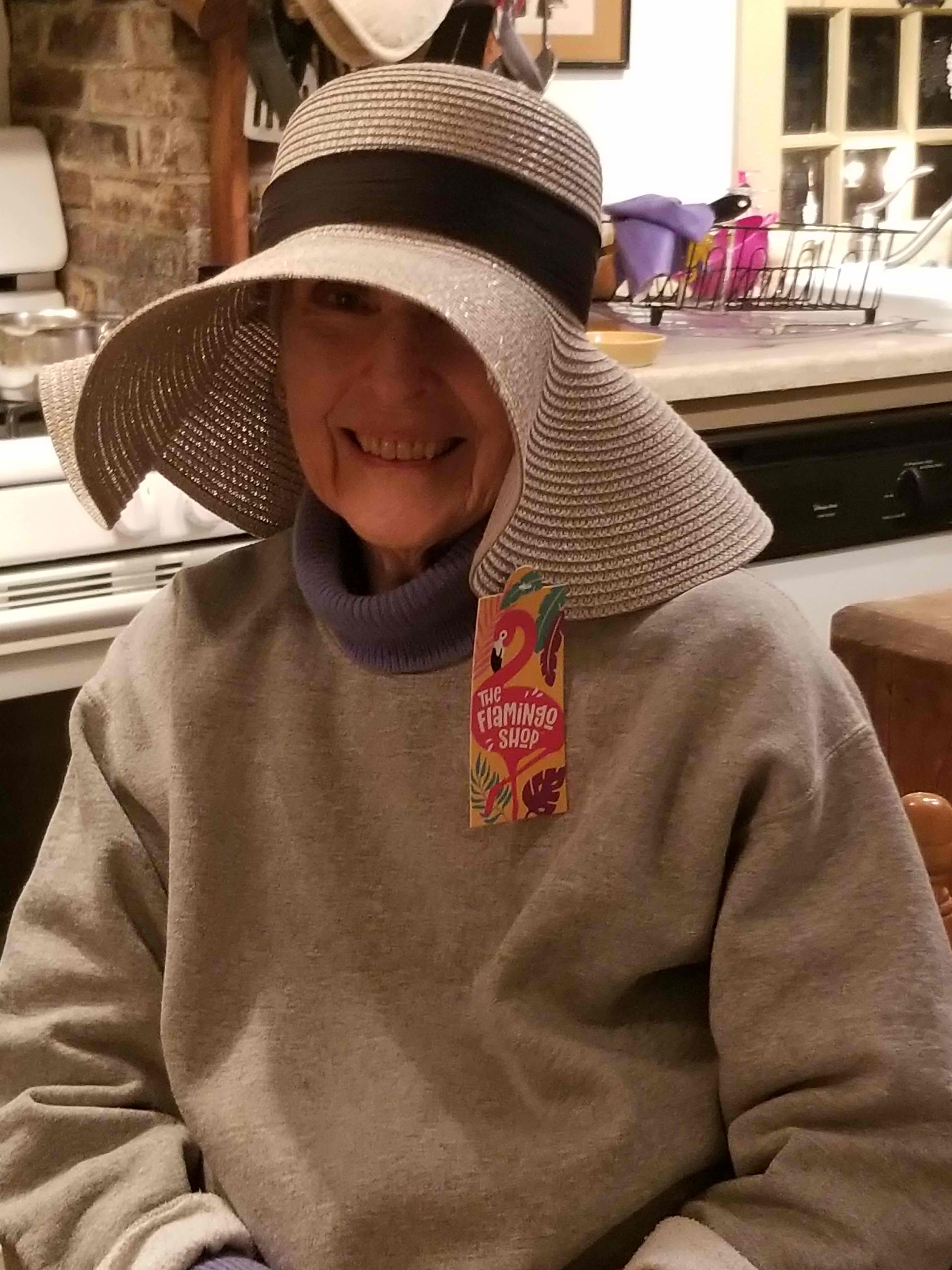 a woman wearing a hat and a tag that says spring on it