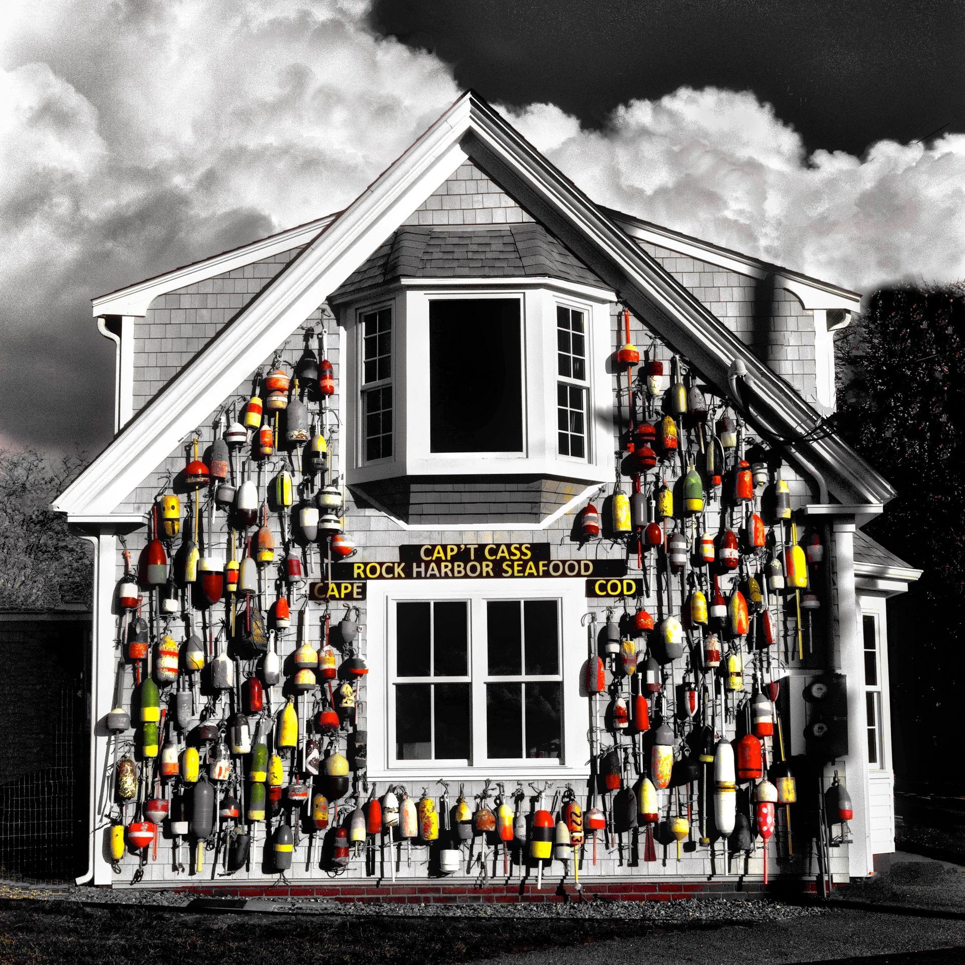 a black and white photo of a house with buoys on it