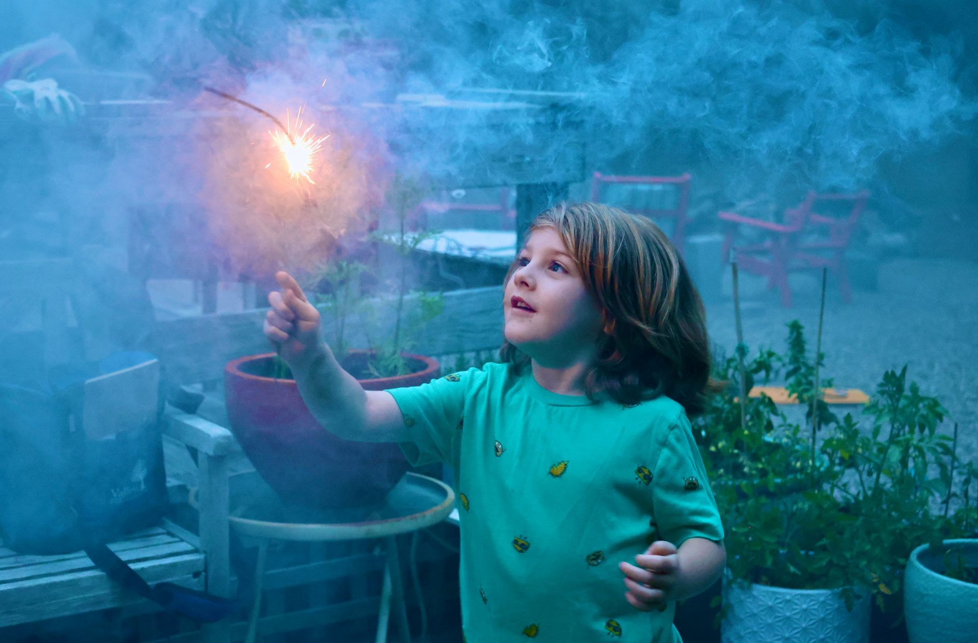 a little girl is holding a sparkler in her hand .