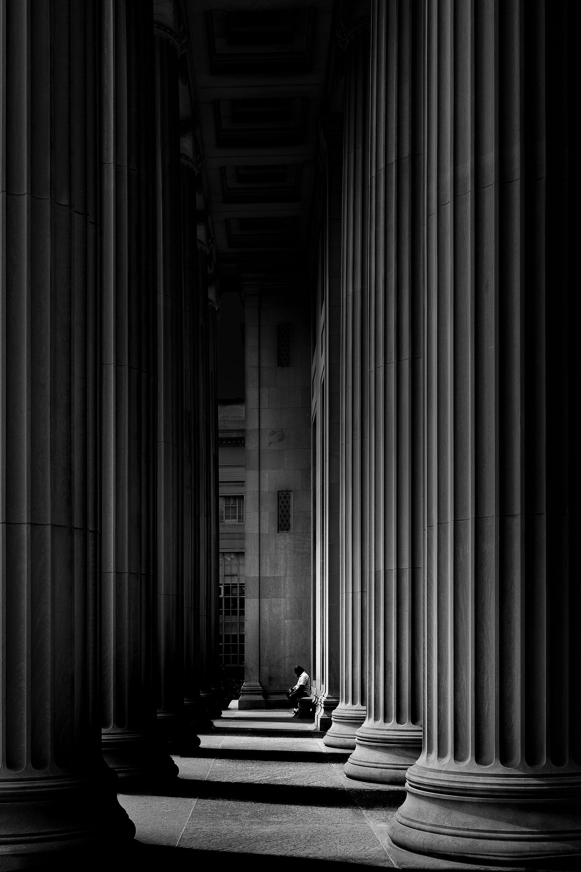 A black and white photo of a row of columns in a building.