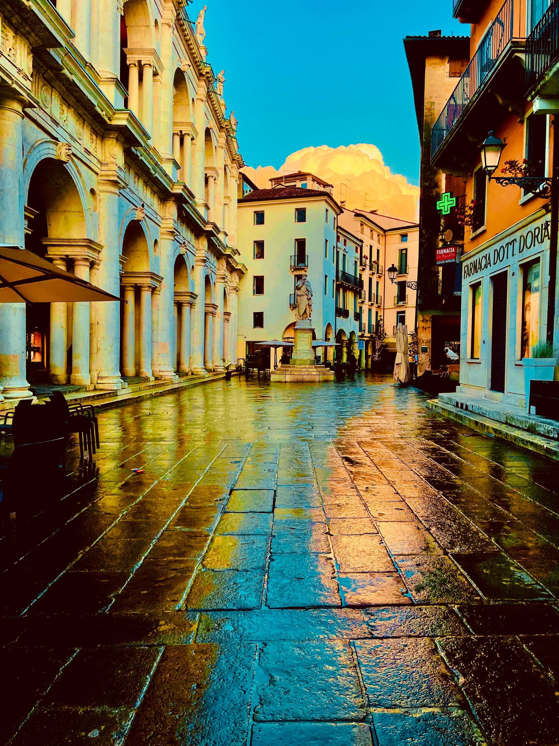 a city street with a pharmacy on the right
