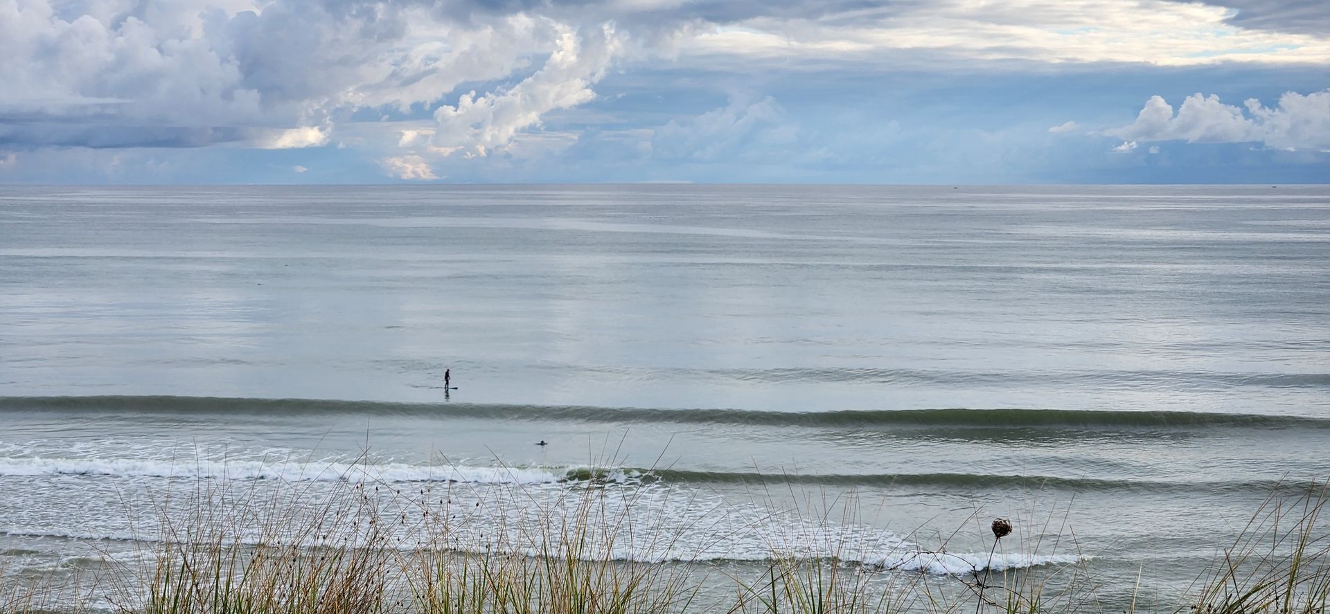 a person is standing on a surfboard in the ocean .