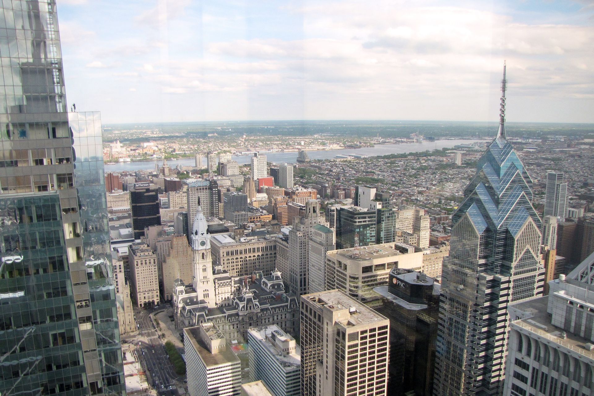 A group of young people are posing for a picture in front of a tree.