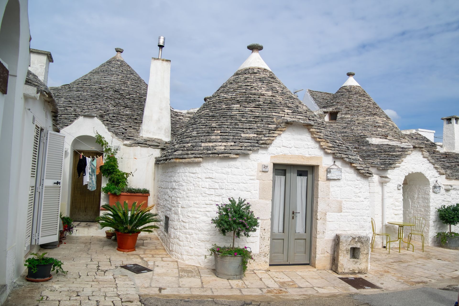 a row of white houses with a gray roof