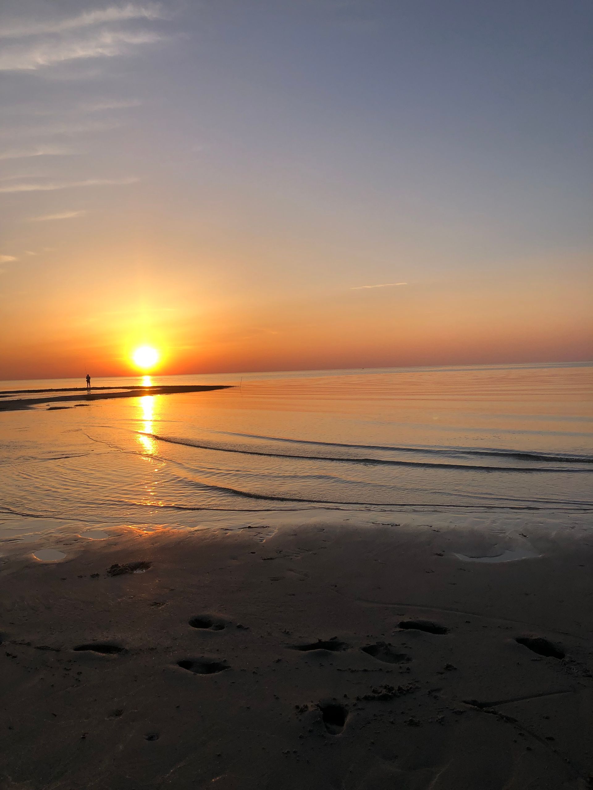 the beach at sunset .