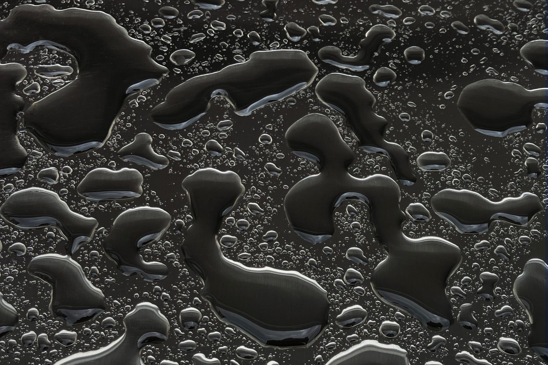 A close up of water drops on a black surface