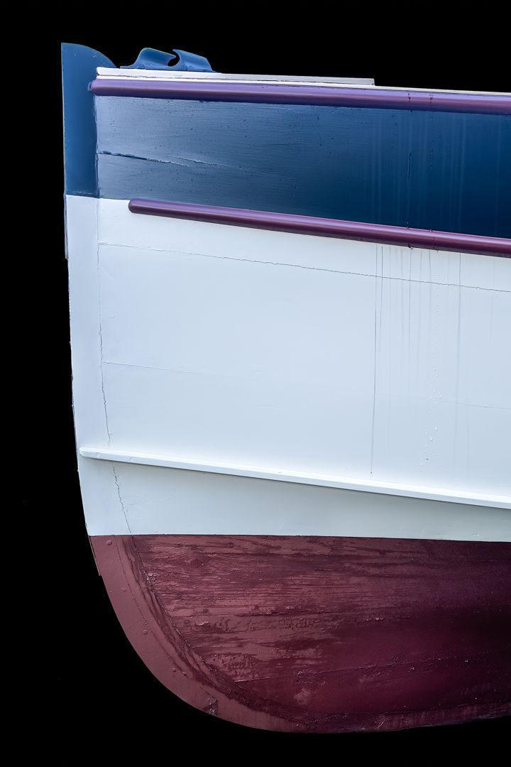 A blue white and purple boat on a black background