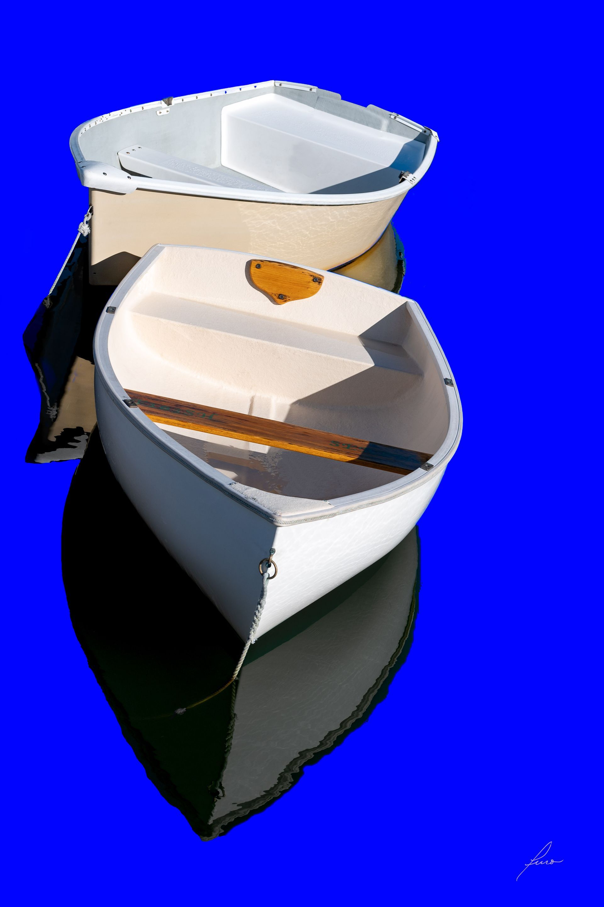 two white boats are stacked on top of each other on a blue background