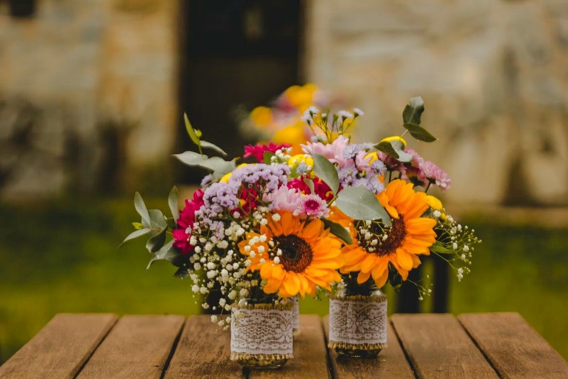 Colorful floral arrangements on a wooden table, symbolizing remembrance and comfort for Quincy, MA funeral and cremation services