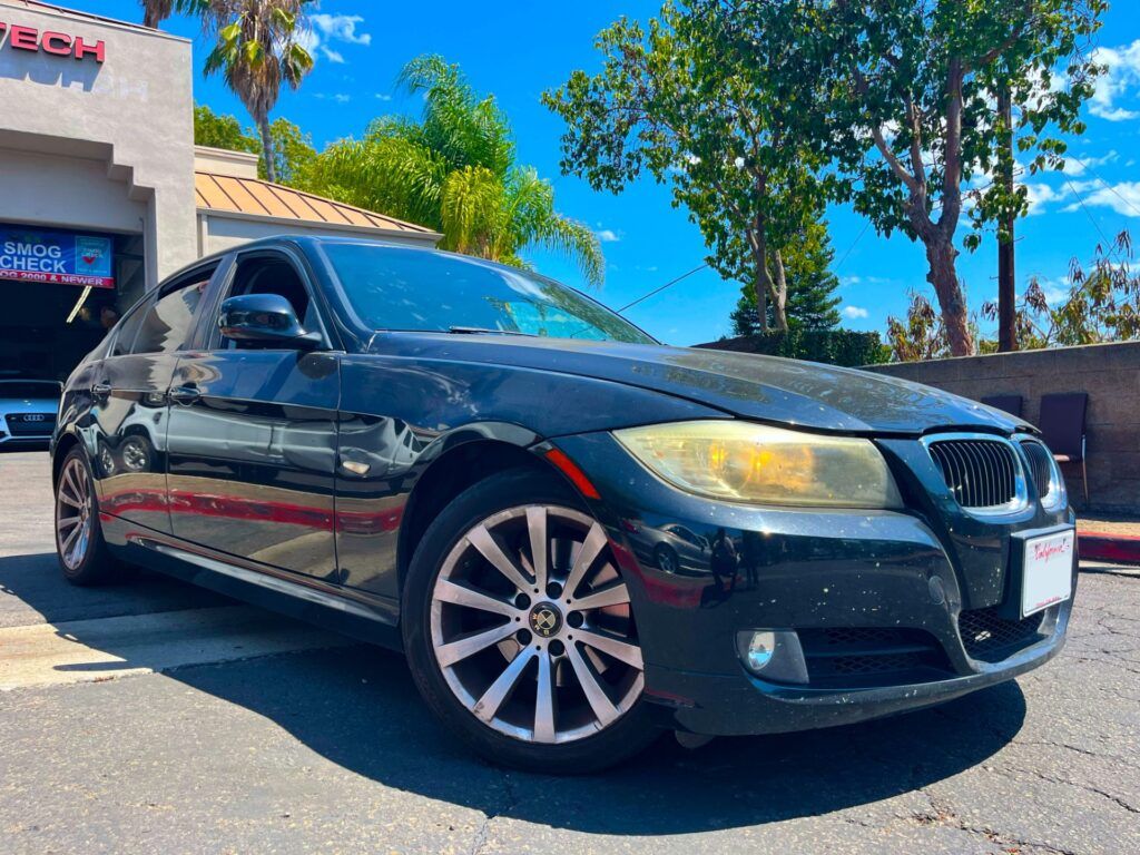 Black 2011 BMW 328i parked outside of our shop | Euro Auto Tech & Smog