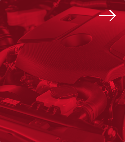 A close-up view of a car engine under a red filter, with a white arrow pointing to the right | Euro Auto Tech & Smog