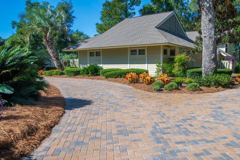A house with a brick driveway leading to it