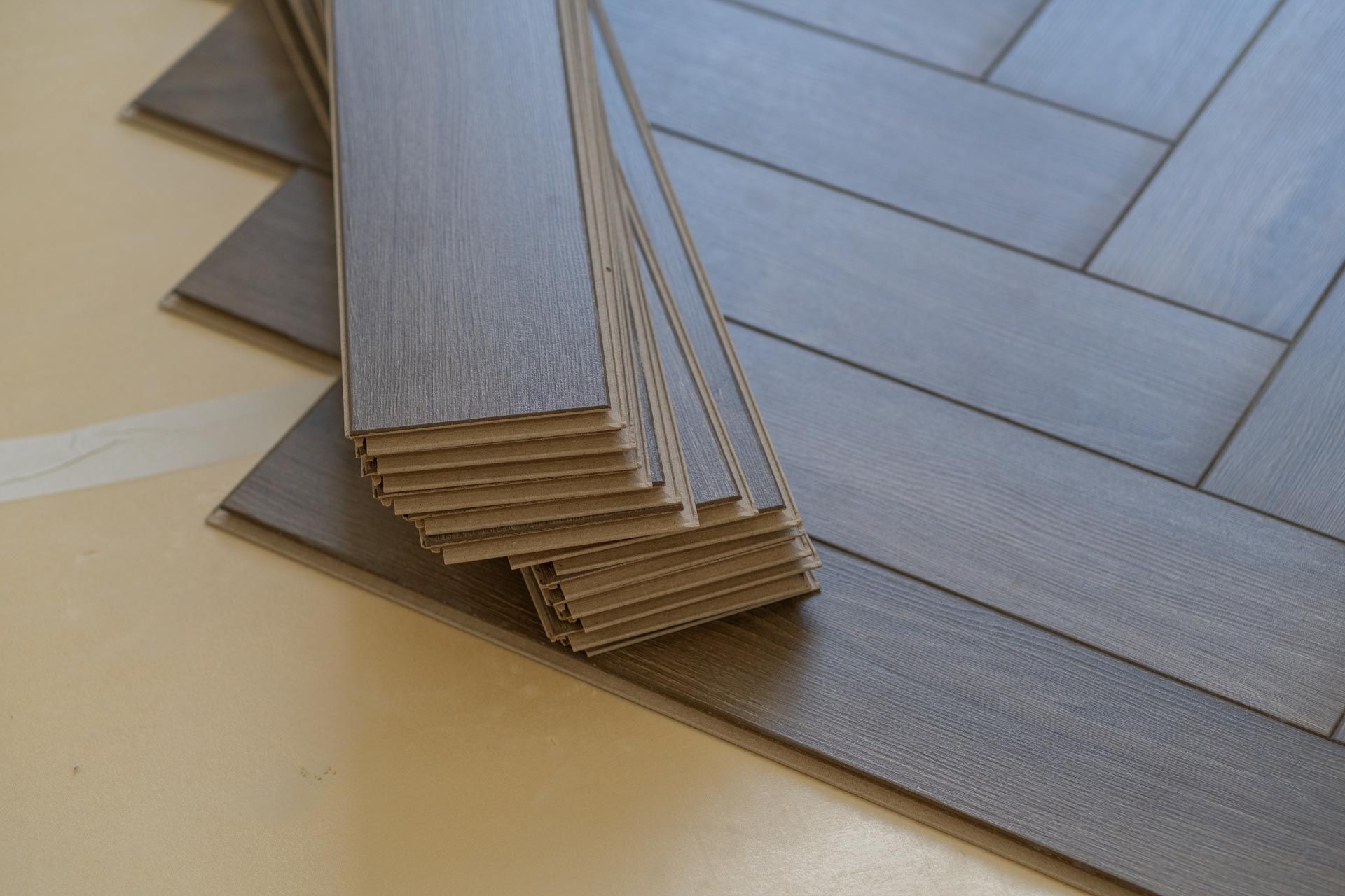 A stack of wooden flooring sitting on top of each other on a table.
