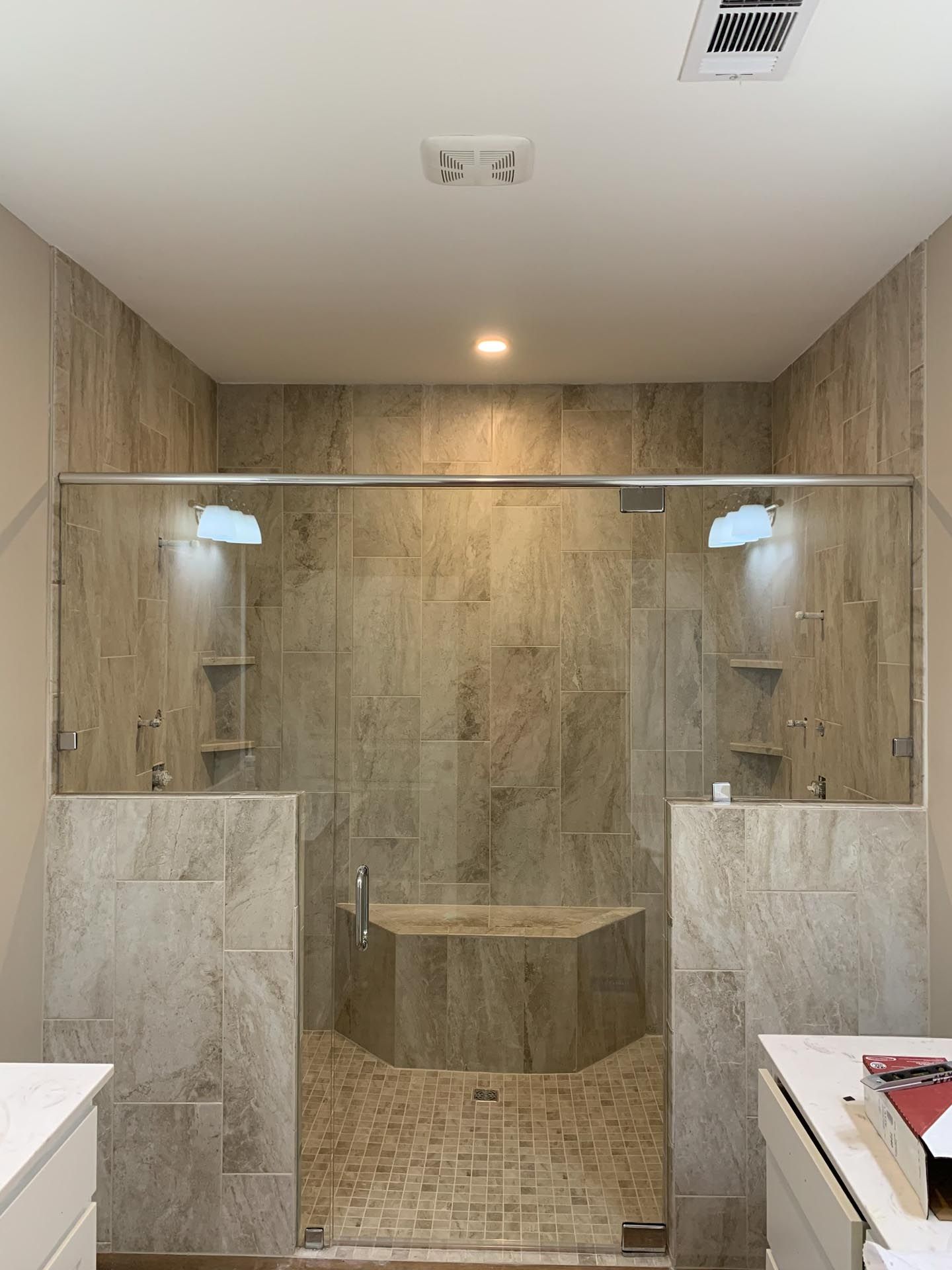 A bathroom with a walk in shower and a bathtub.