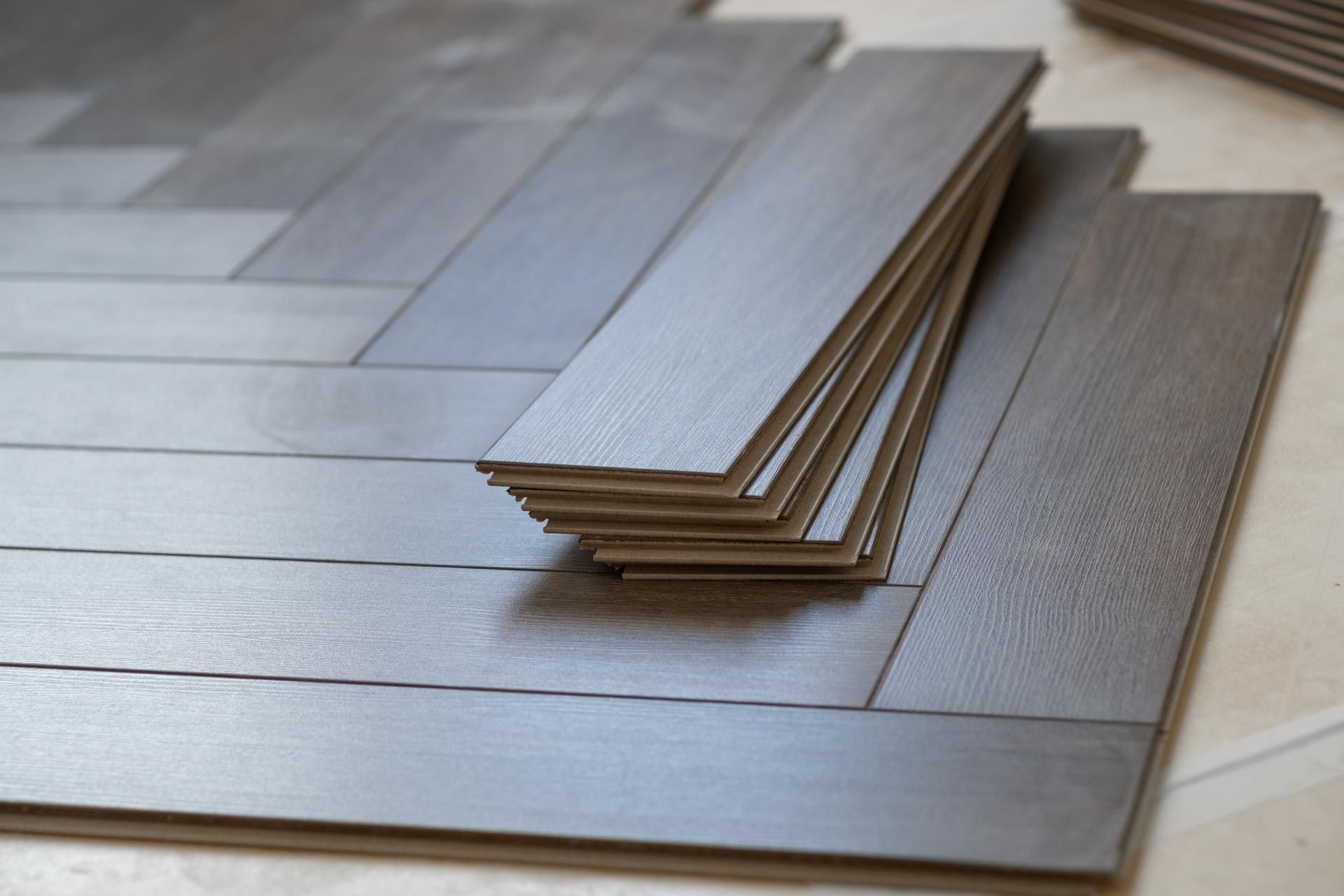 A stack of wooden flooring is laying on the floor.