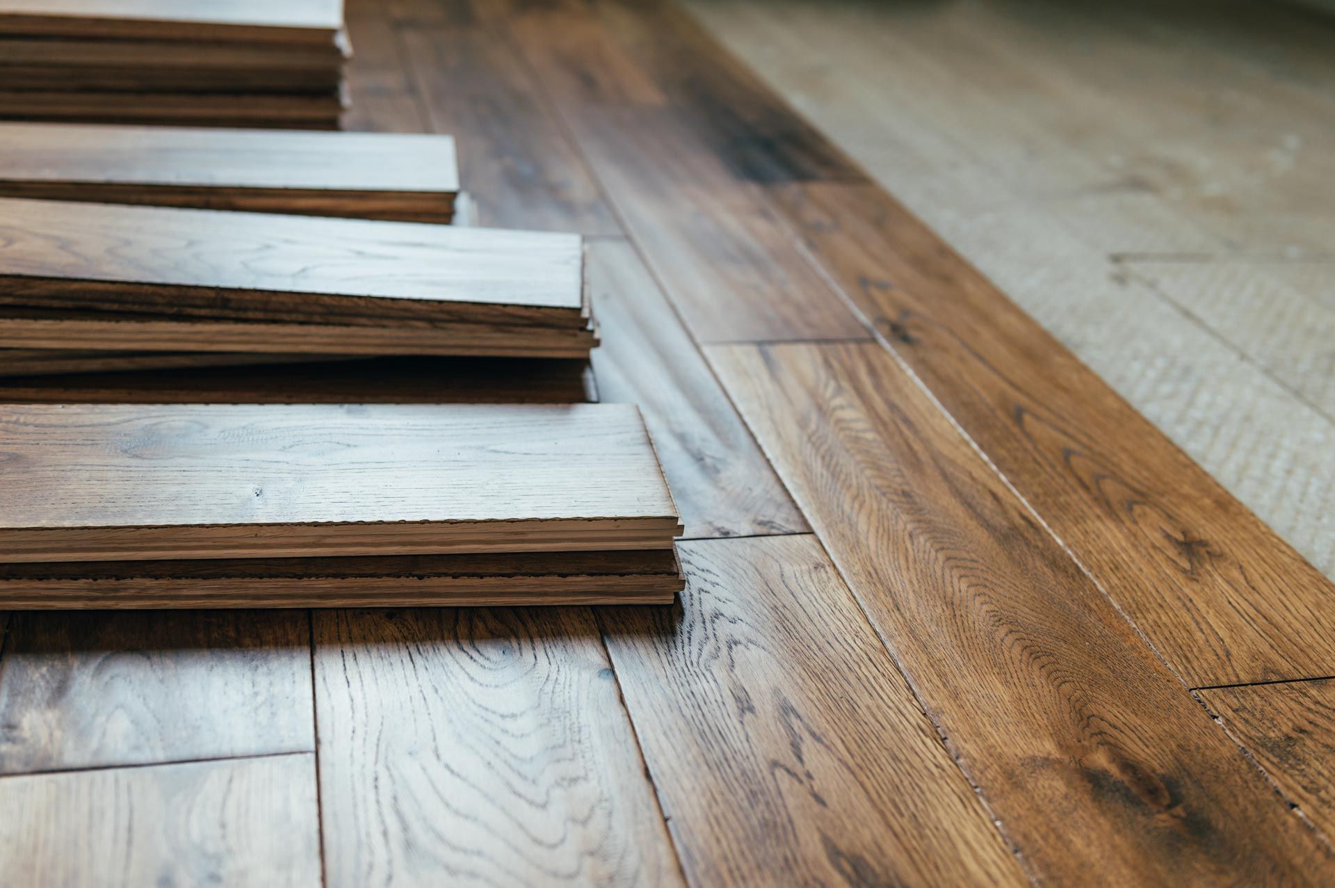 A stack of wooden planks sitting on top of a wooden floor.