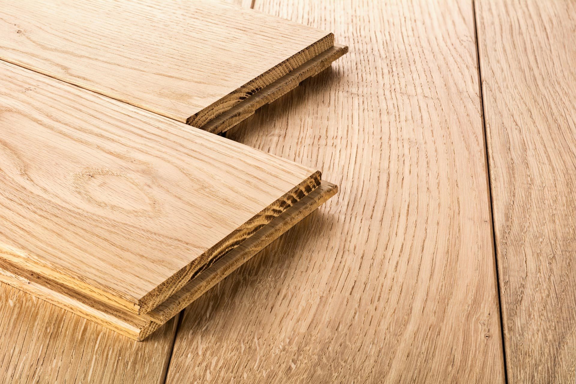 Two pieces of wood are stacked on top of each other on a wooden table.