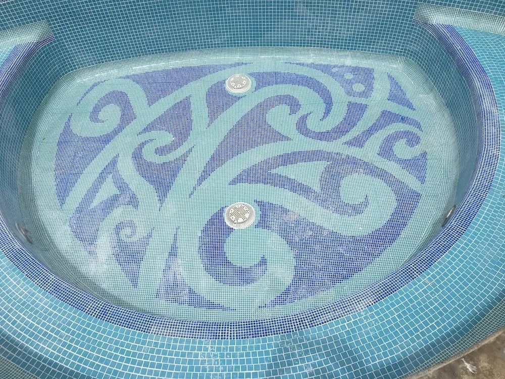Circular blue-patterned surface with two small round objects in the center