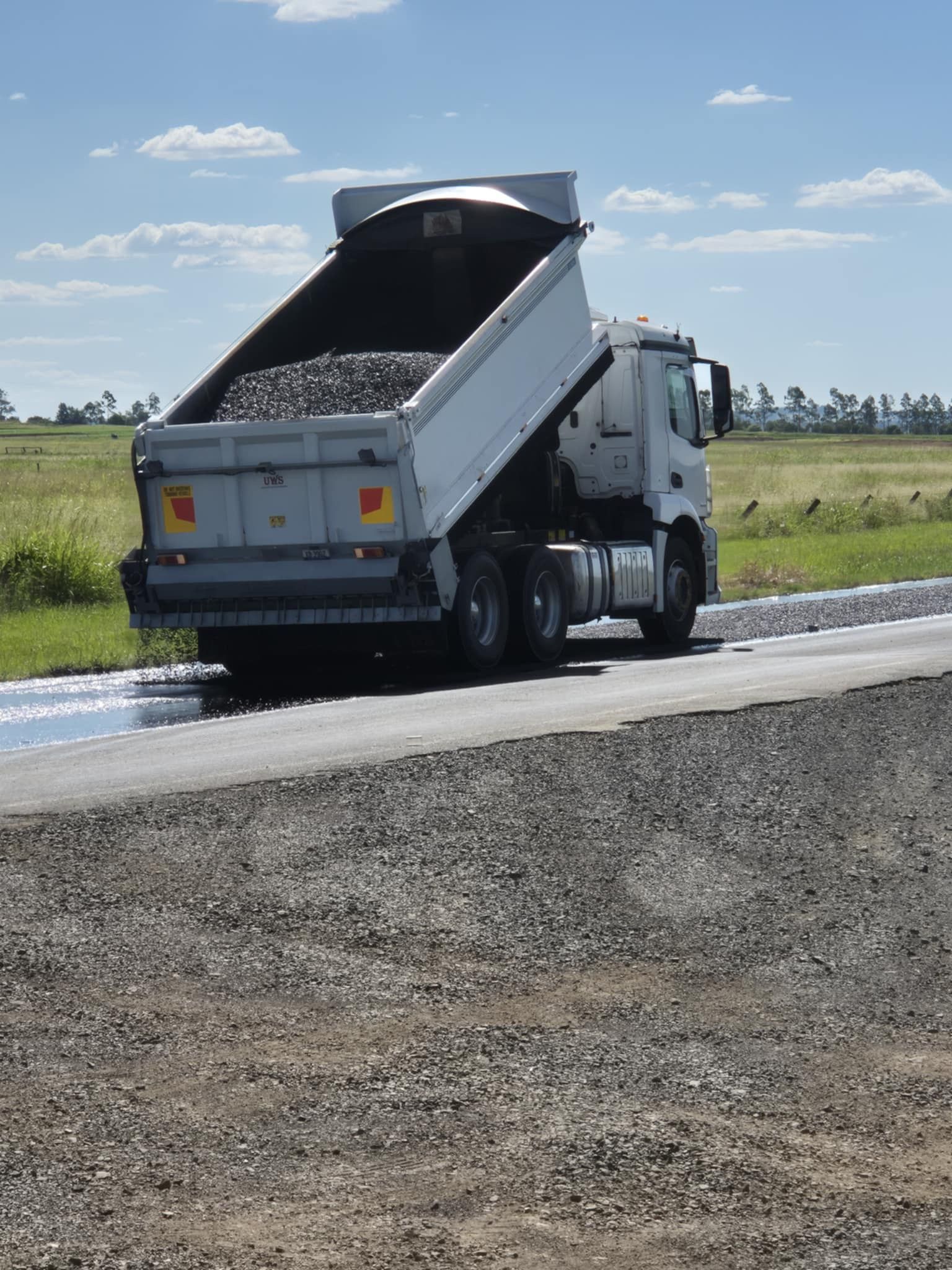 Truck holding asphalt driving on a highway — Appian Roads In Urangan, QLD