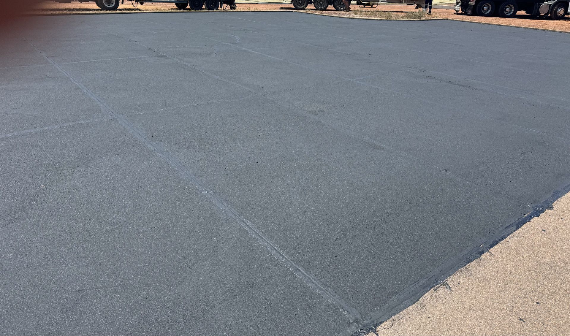A Parking Lot With Cars Parked Under A Canopy — Appian Roads In Urangan, QLD