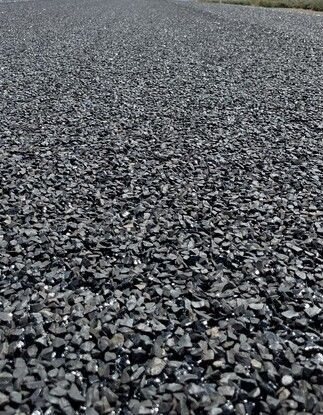 A Road Is Being Paved With A Roller And A Spreader — Appian Roads In Urangan, QLD