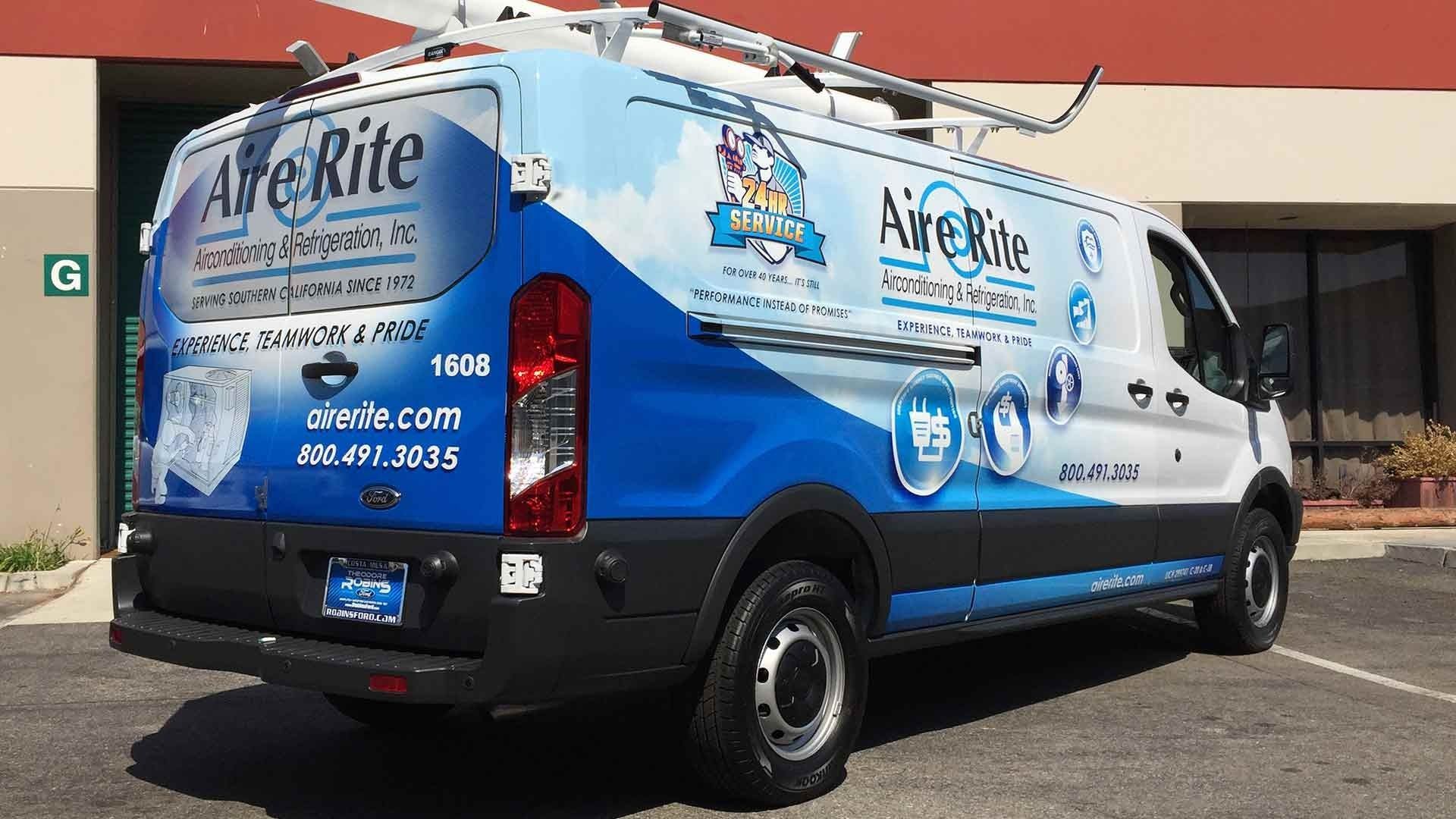 A blue and white Aire Rite service van parked outside a building.