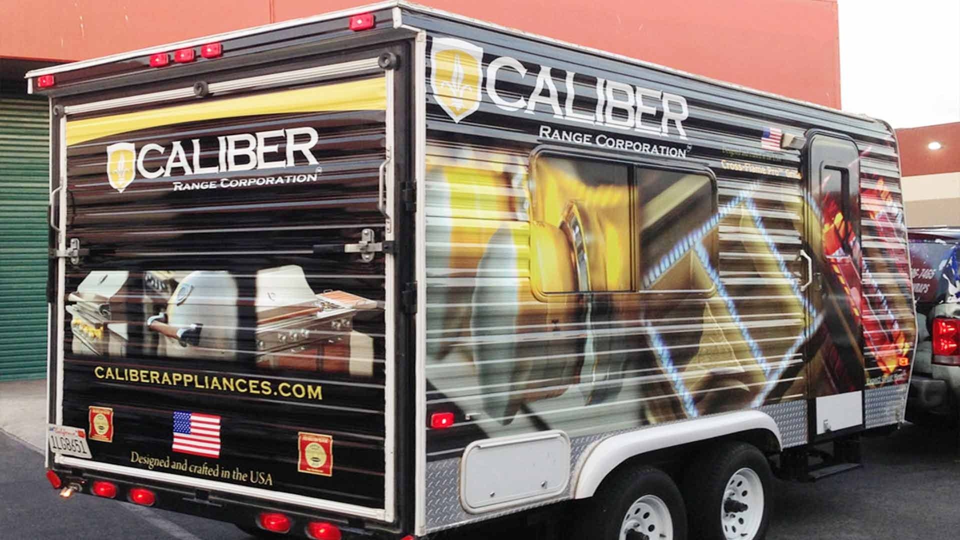 A black, branded Caliber Appliances mobile trailer parked outdoors.