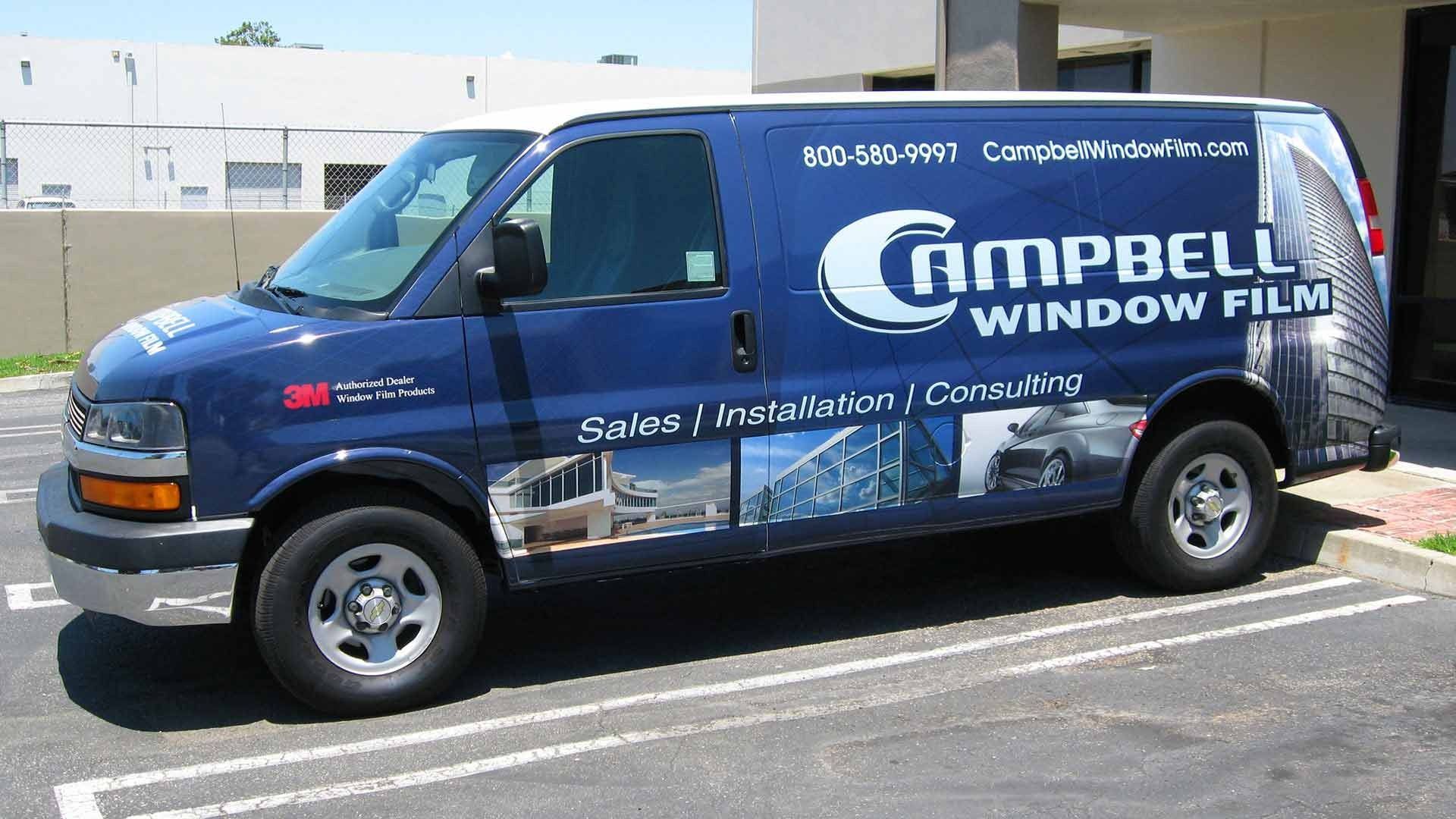 A blue Campbell Window Film work van parked in a lot, featuring 3M branding and company service information.