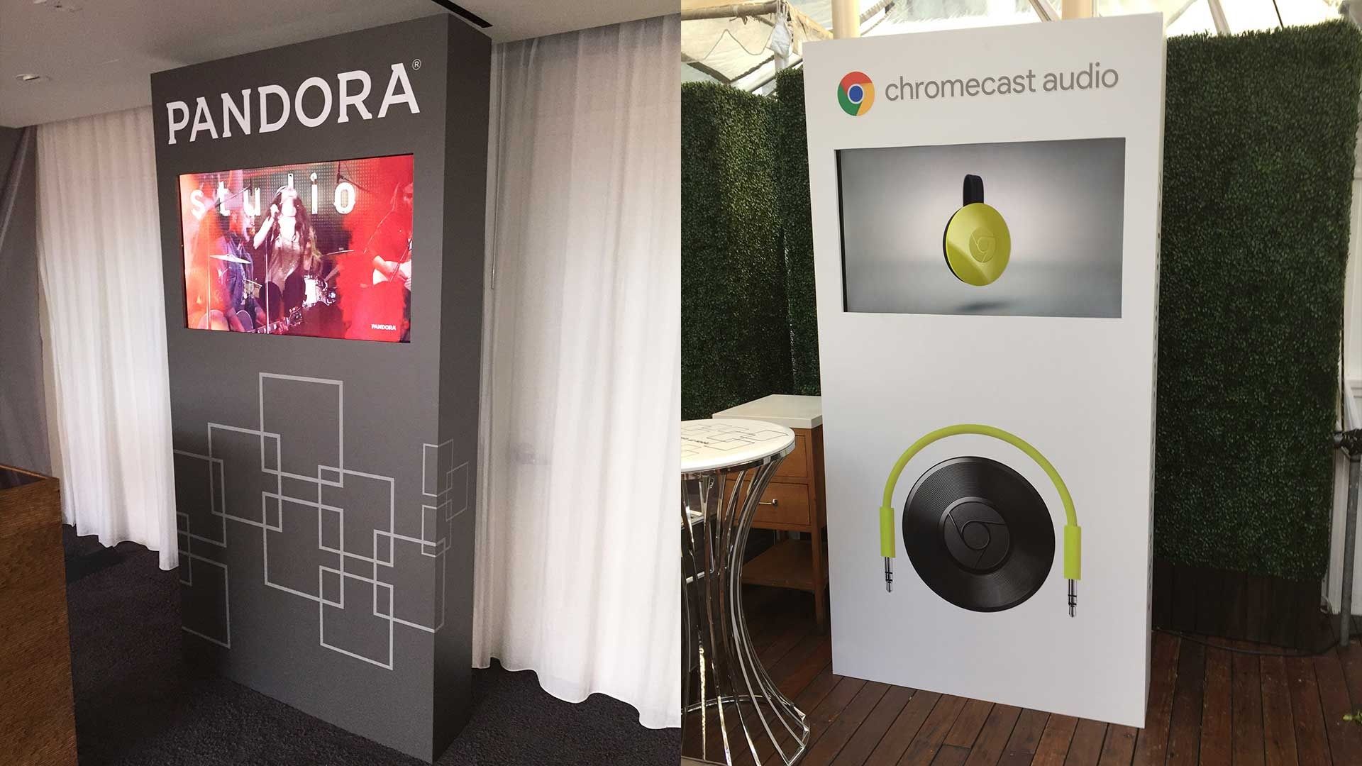 Two vertical display stands, one branded Pandora and the other Chromecast Audio, standing side-by-side in a room.