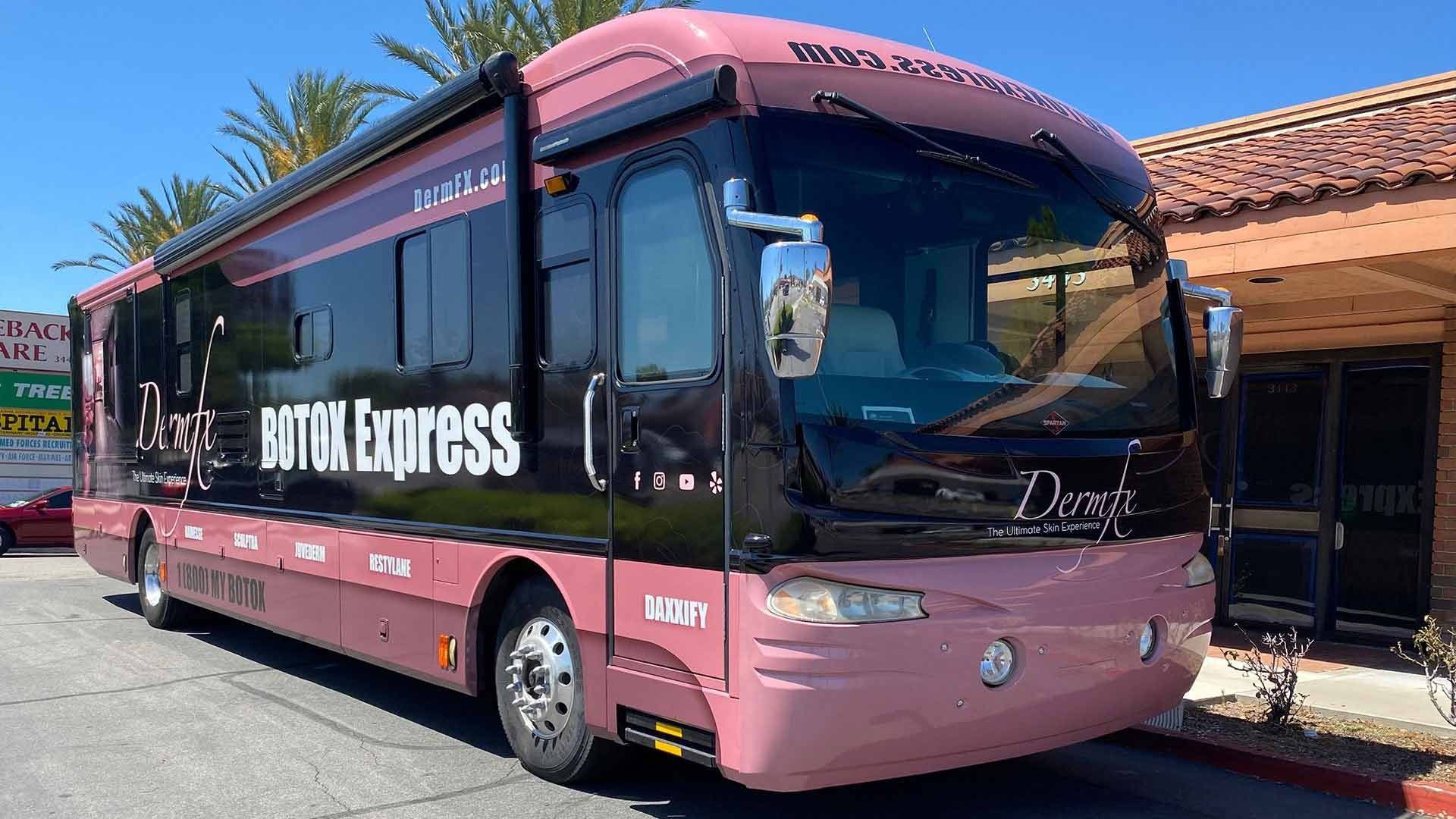 A pink and black Doughnut-themed bus, labeled 