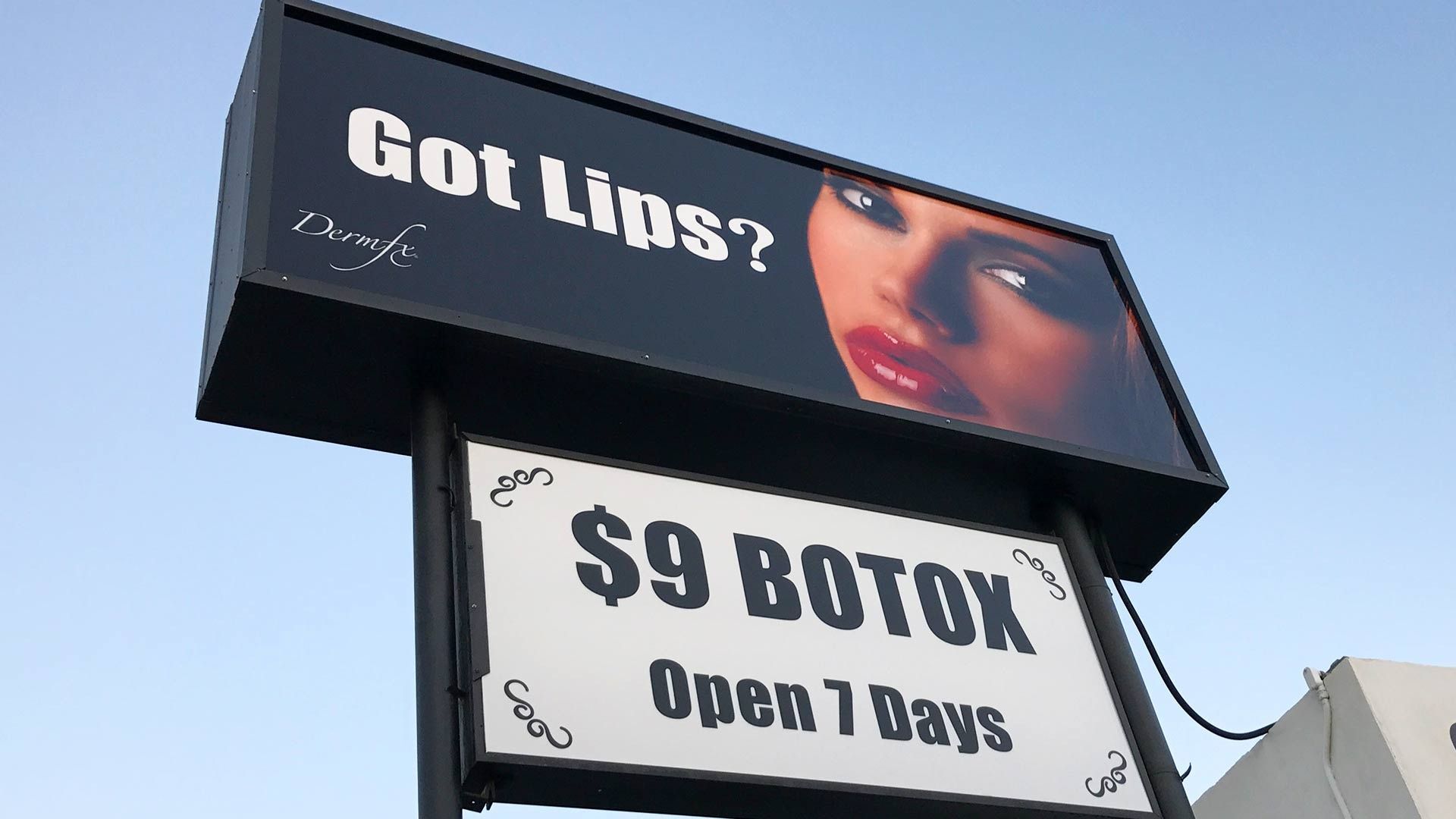 A sign against a blue sky advertises 