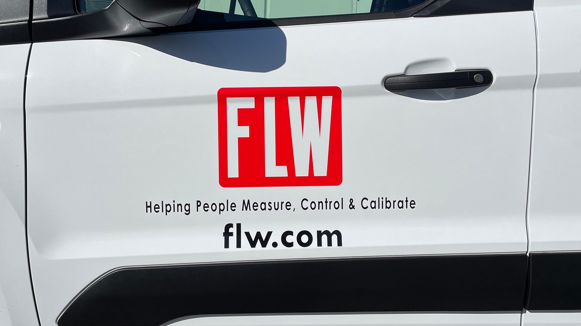 A white vehicle door features a red 