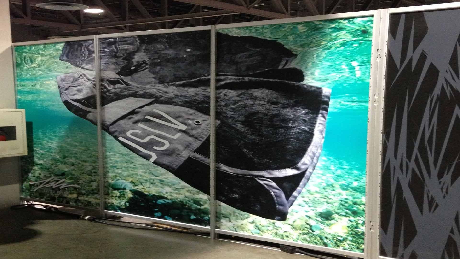 Large illuminated display showing a submerged dark object with 