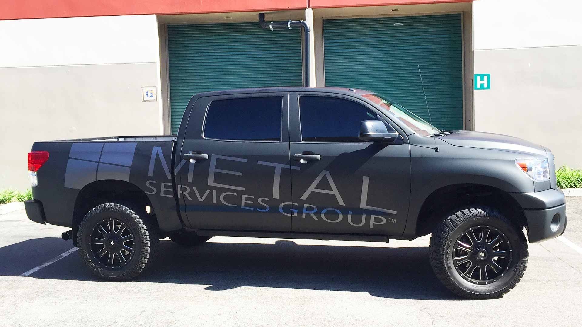 A matte black pickup truck with 