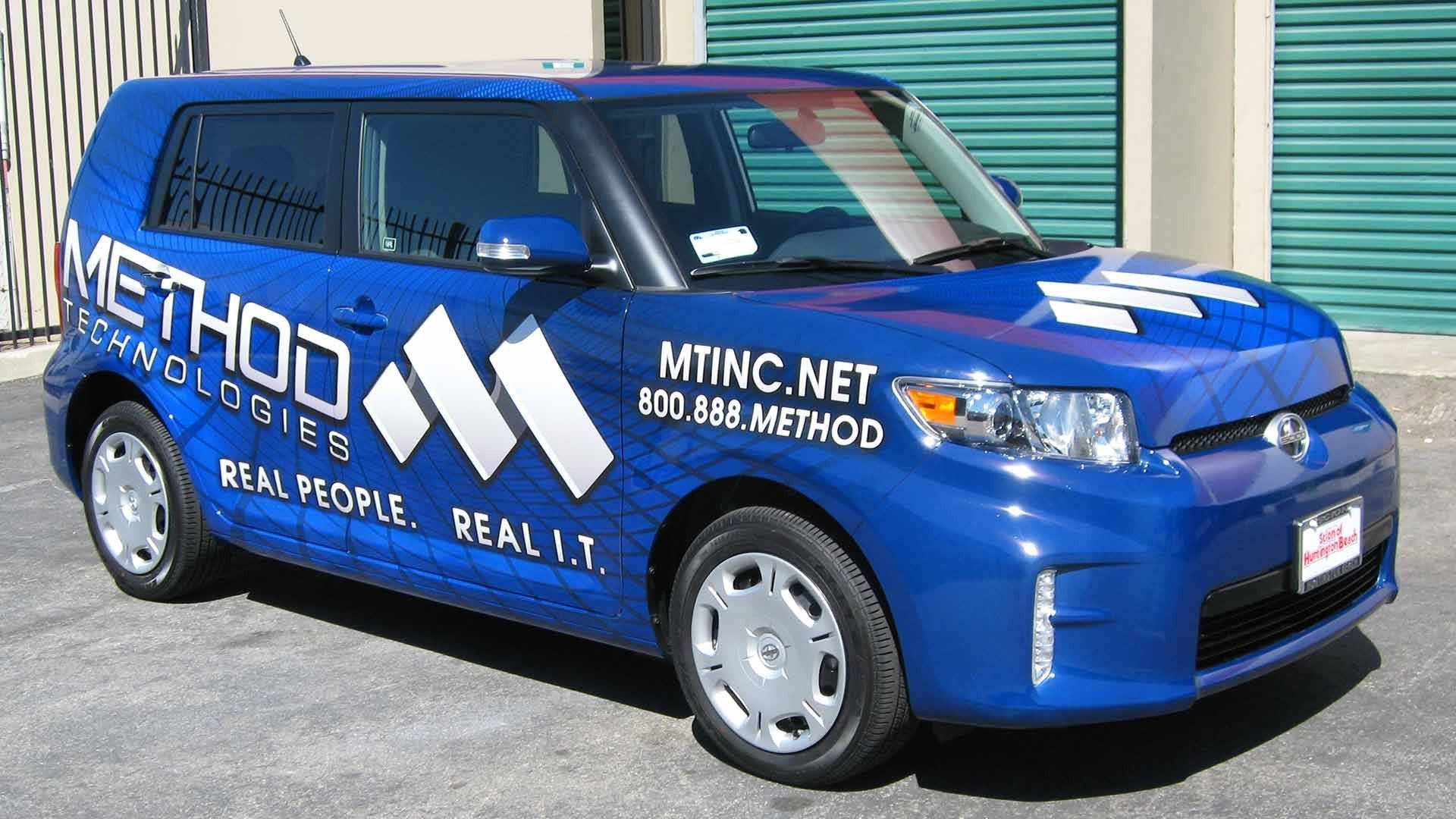 A blue car featuring white logos and text for 