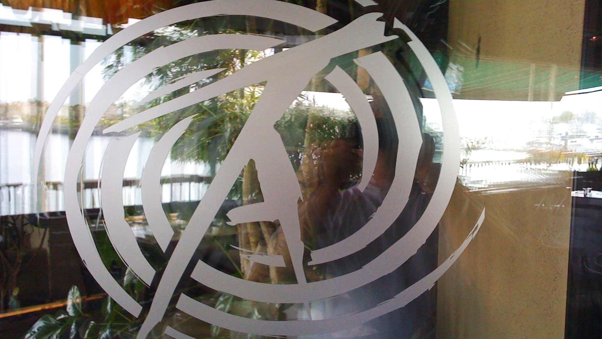 A frosted vinyl logo of the letter 