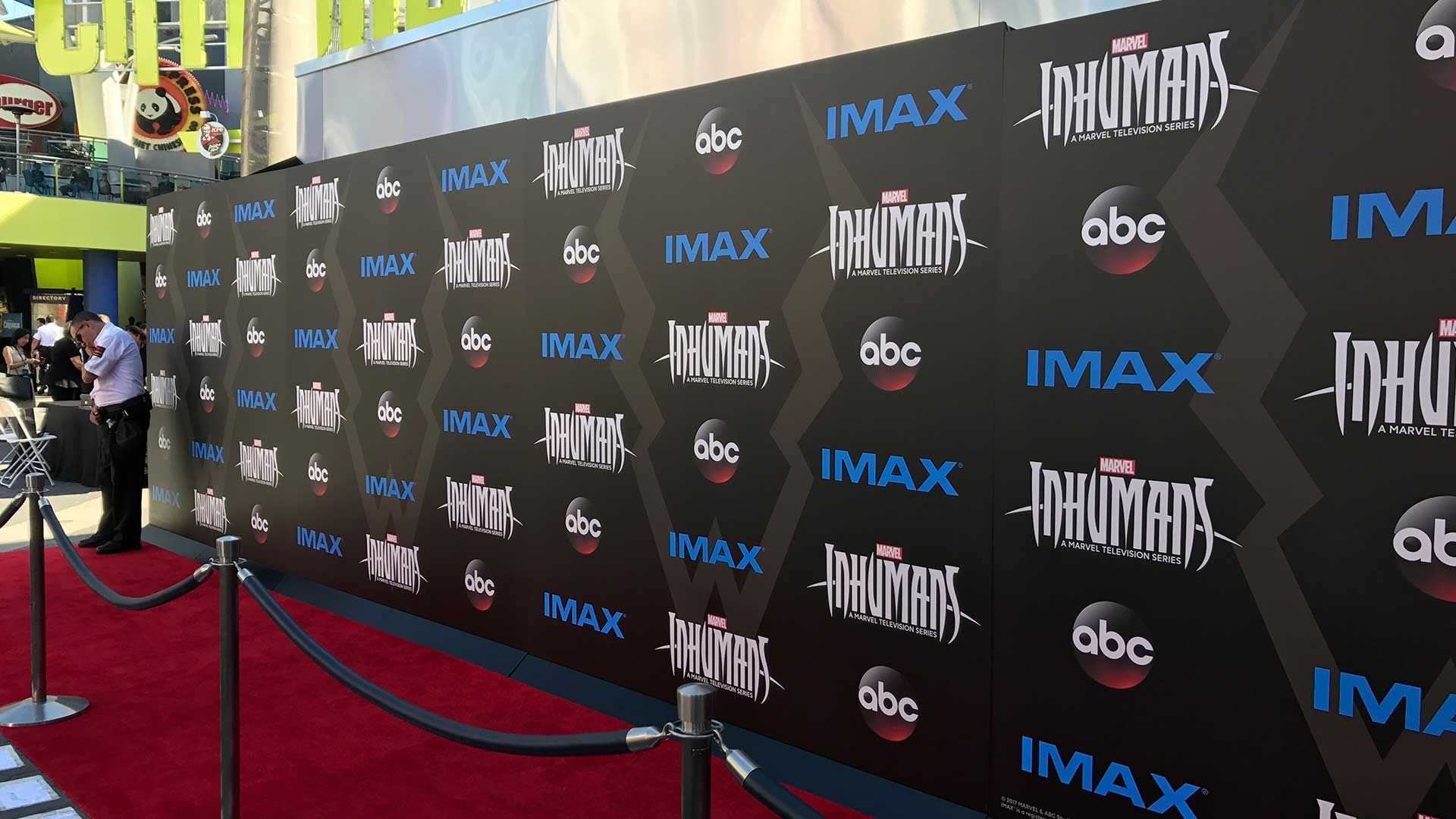 A red carpet leads to a black step-and-repeat backdrop featuring Marvel’s Inhumans, IMAX, and ABC logos.