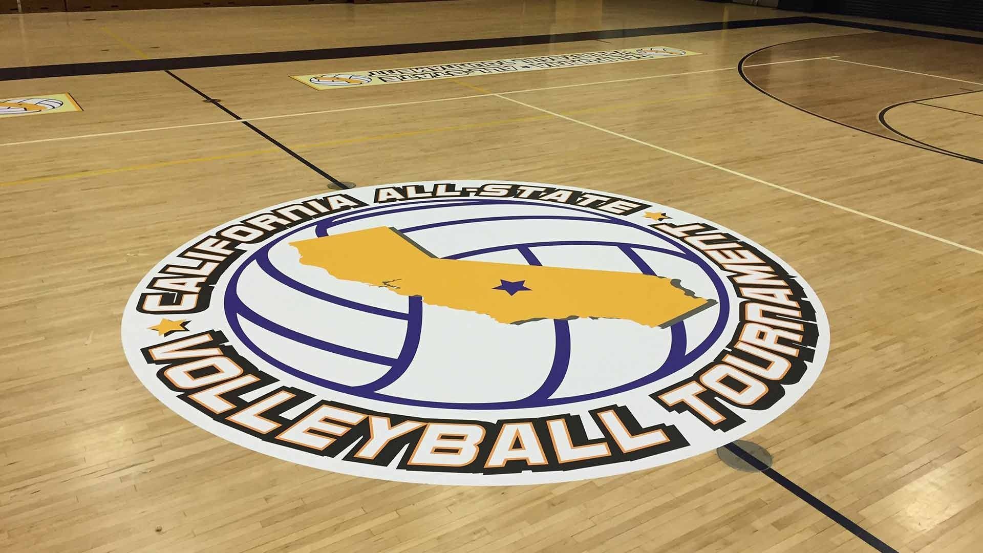 A California Amateur Volleyball Tournament logo printed on a hardwood indoor gymnasium floor.