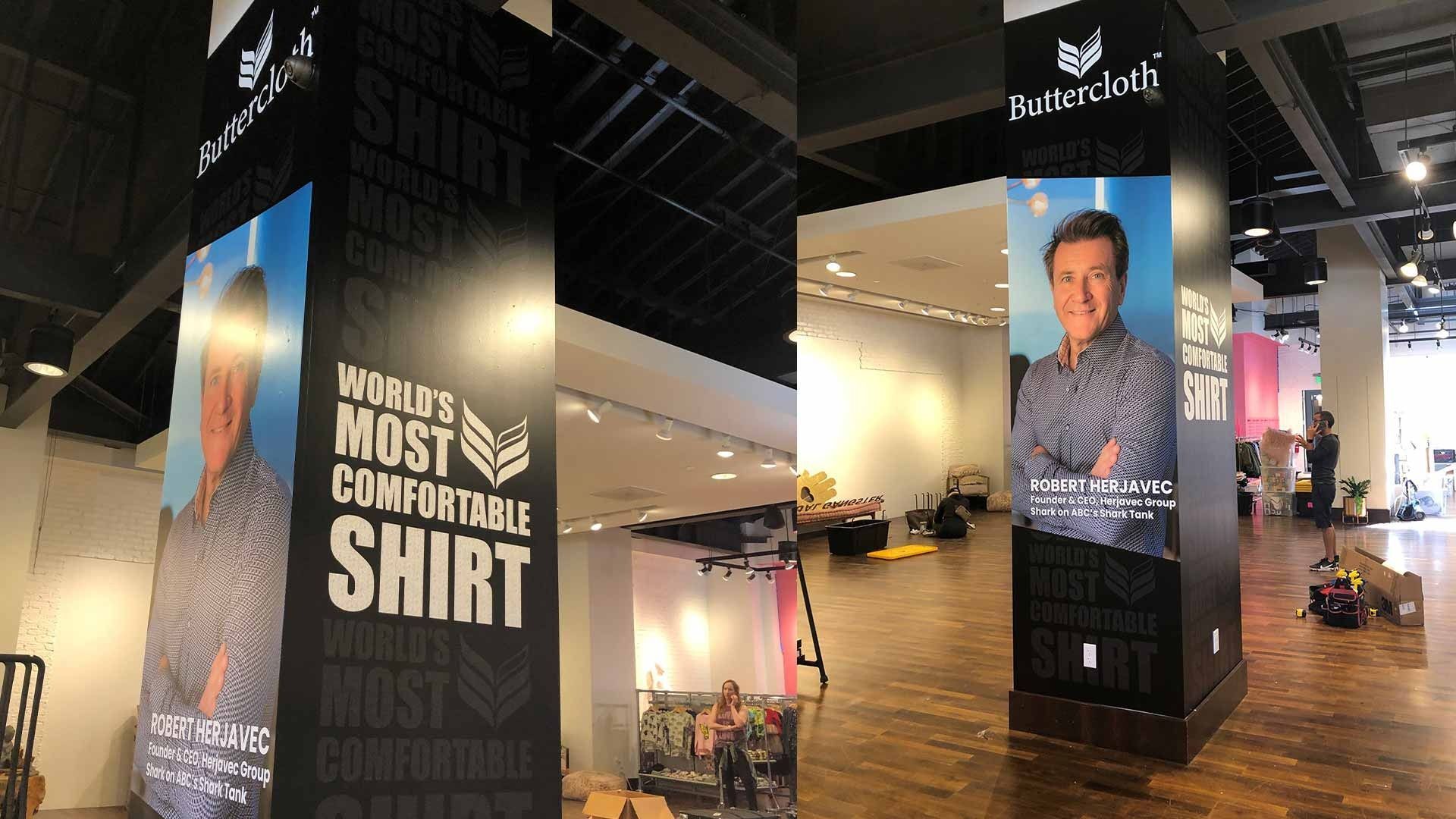 Two sides of a black pillar in a store display the slogan 