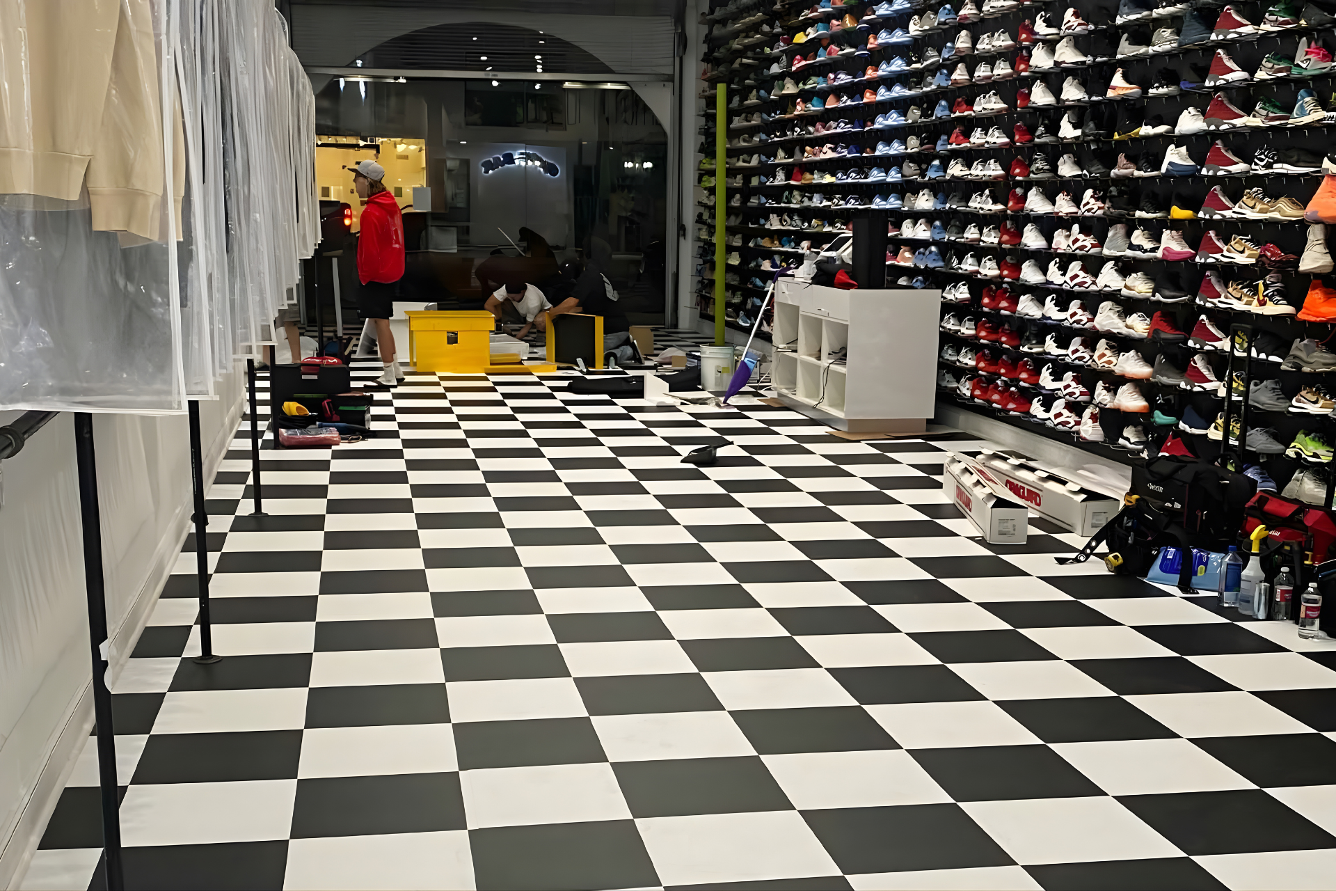 A multi-colored backdrop display with a sky-patterned floor, cordoned off by stanchions in an indoor setting.