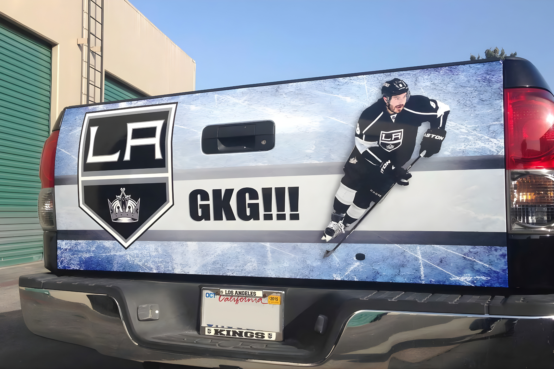 A black pickup truck with blue and red 